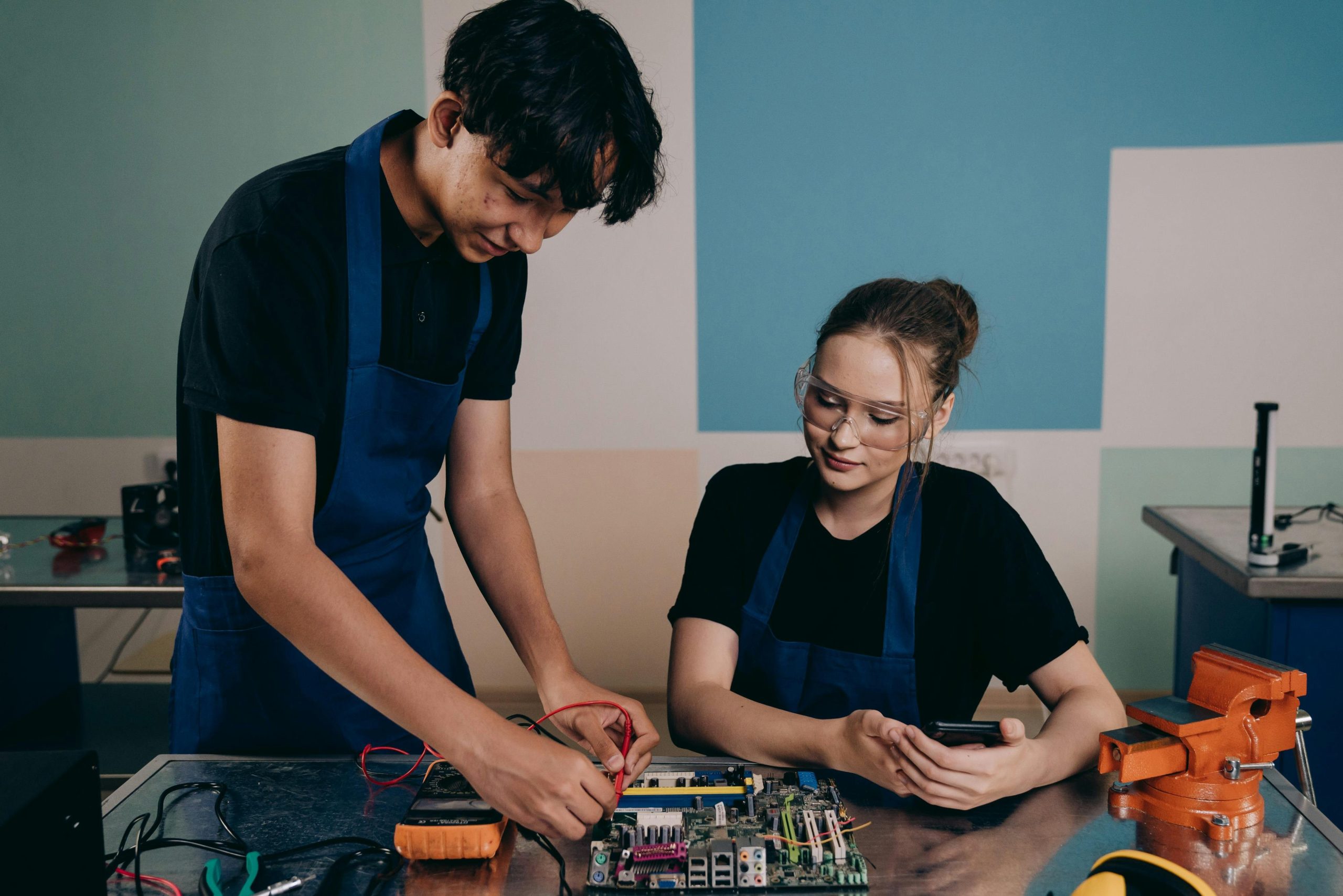 Engineers performing environmental stress tests on a satellite prototype in a lab setting