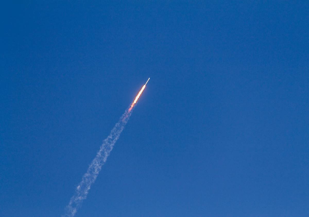 A rocket launching into space with fiery exhaust plumes.